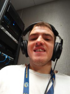Brandon Lewis with broadcaster headphones